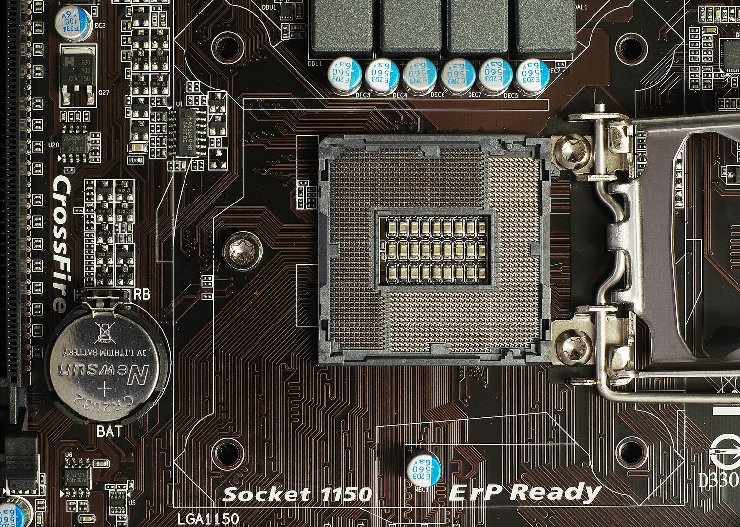 A square CPU socket on a motherboard, with a grid of tiny pins and a metal retention lever, surrounded by circuit tracks