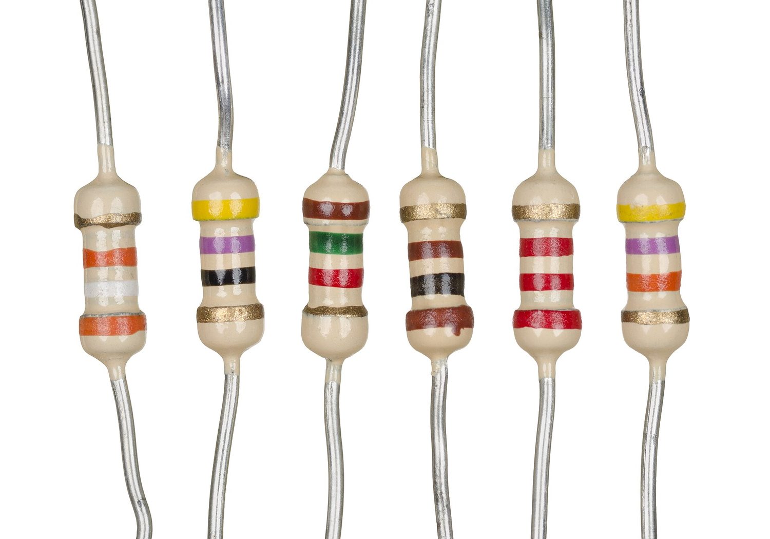 Six real fixed resistors in a row on a white background, each a small barrel with metal wire leads and several coloured bands painted around it that code its resistance value