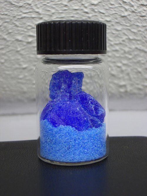 A cluster of large, glassy, bright blue crystals of copper sulfate