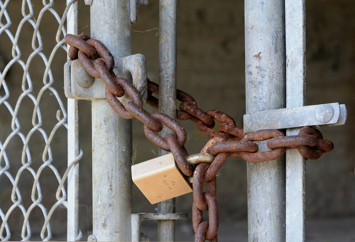 A padlock on a chain: physical security is the first layer — locks, doors and barriers matter