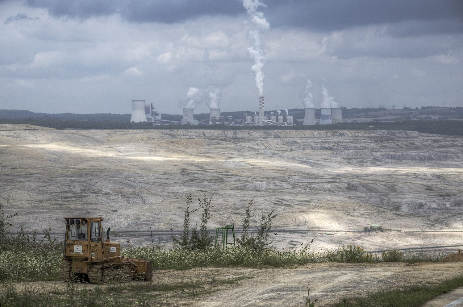 An open-pit lignite coal mine, with the burning power station just behind it: the fuel is dug straight out of the ground and burned on the spot