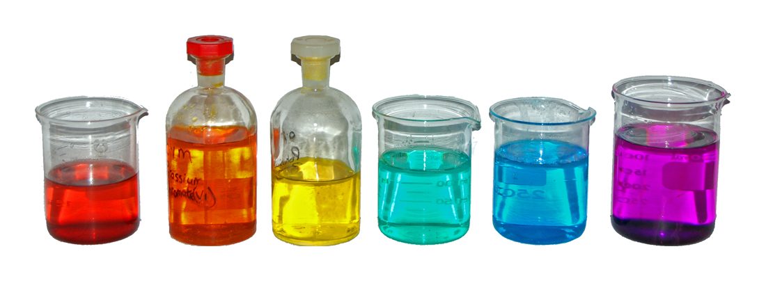 Six beakers of brightly coloured solutions — red, orange, yellow, green, blue and purple