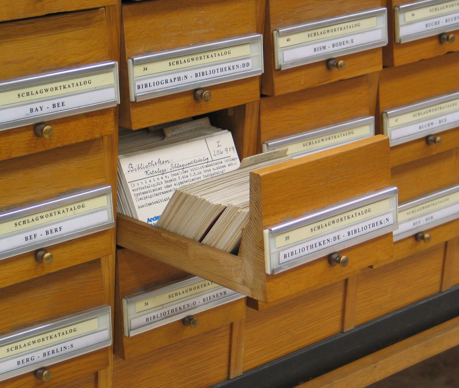 Rows of small labelled drawers in a library card catalogue