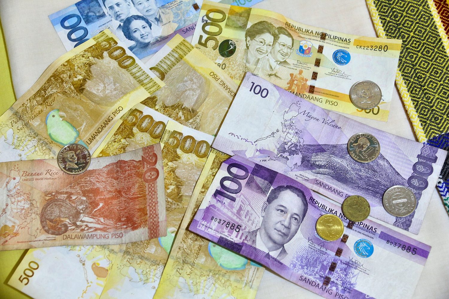 Many different banknotes and coins laid out together