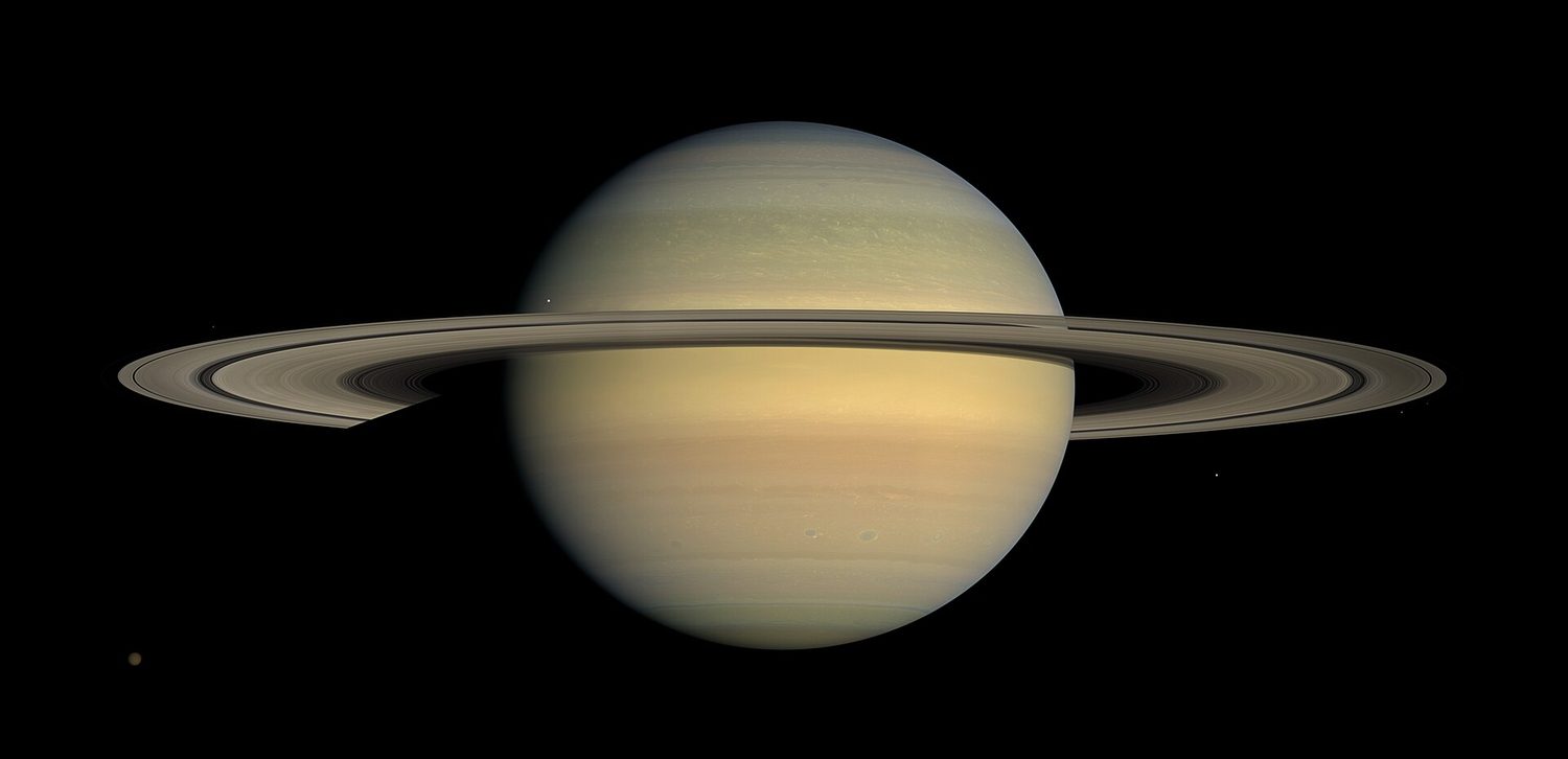 Saturn with its wide, flat system of rings, photographed from the side by the Cassini spacecraft