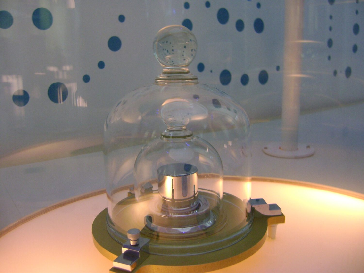A replica of the prototype kilogram, a metal cylinder kept under glass jars